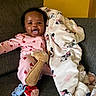 Dahlia is registered to the contest to win money with this photo: baby, blanket, child, couch, cozy, cute, furniture, giraffe, happy, indoors, infant, ladybug, minnie_mouse, pacifier, pajamas, person, plush_toy, relaxing, smiling, soft