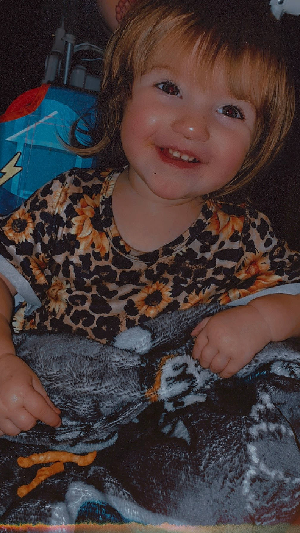 Oaklynn Michelle Mia is registered to the contest to win money with this photo: bangs, black, blond, brown_hair, cheek, child, chin, eye, facial_expression, fun, happy, iris, joy, linens, pattern, person, sitting, skin, sleeve, smile