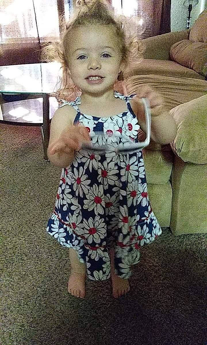 Savannah is registered to the contest to win money with this photo: child, clothing, design, dress, face, family, head, pattern, people, person, play, sitting, smile, summer, toddler, vacation