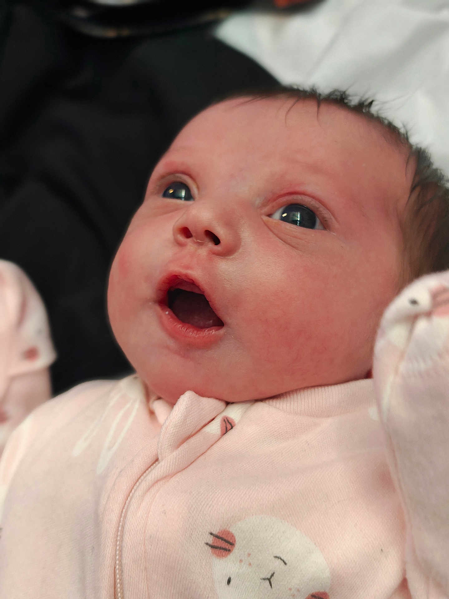 Roseana joined the competition — help win amazing prizes! baby, infant, face, eyes, pink_onesie, clothing, cute, expression, closeup, newborn, soft_lighting, portrait, child, skin, mouth_open, animal_print, adorable, person, baby_garment, indoors