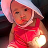 baby, child, face, hat, sunhat, red_clothing, car_seat, infant, cute, portrait, skin, hand, arm, closeup, seat, child_in_car, sunlight, pout, expression, indoors