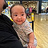 baby, child, adult, man, shopping_mall, store, abercrombie_and_fitch, clothing, floral_outfit, face, holding, portrait, indoor, floor, people, mustache, beard, curious, smiling, casual