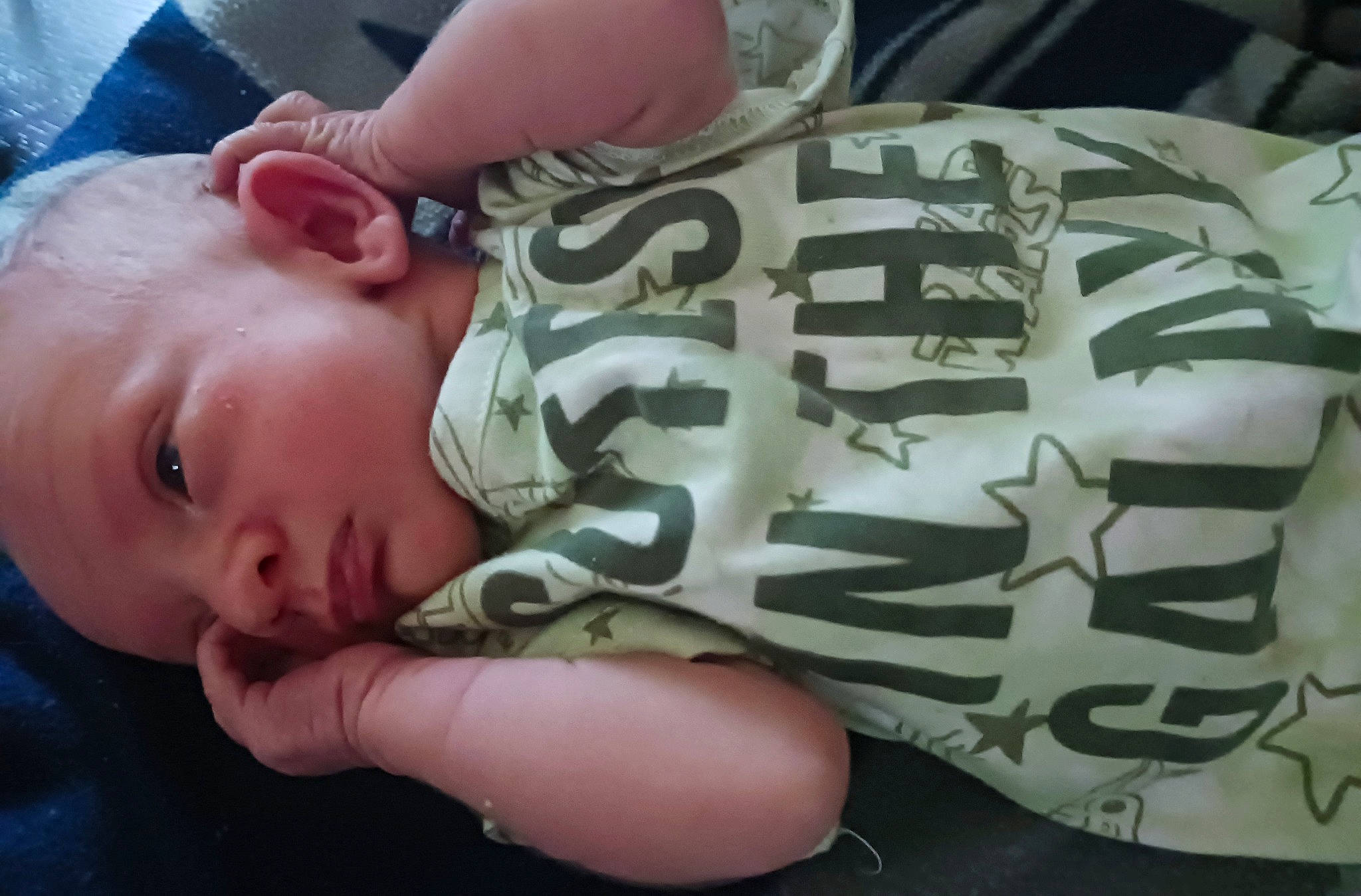 William is registered to the contest to win money with this photo: baby, baby_toddler_clothing, cheek, child, comfort, ear, elbow, eyelash, finger, forehead, hand, mouth, nail, nose, pattern, person, sitting, skin, sleeve, thumb