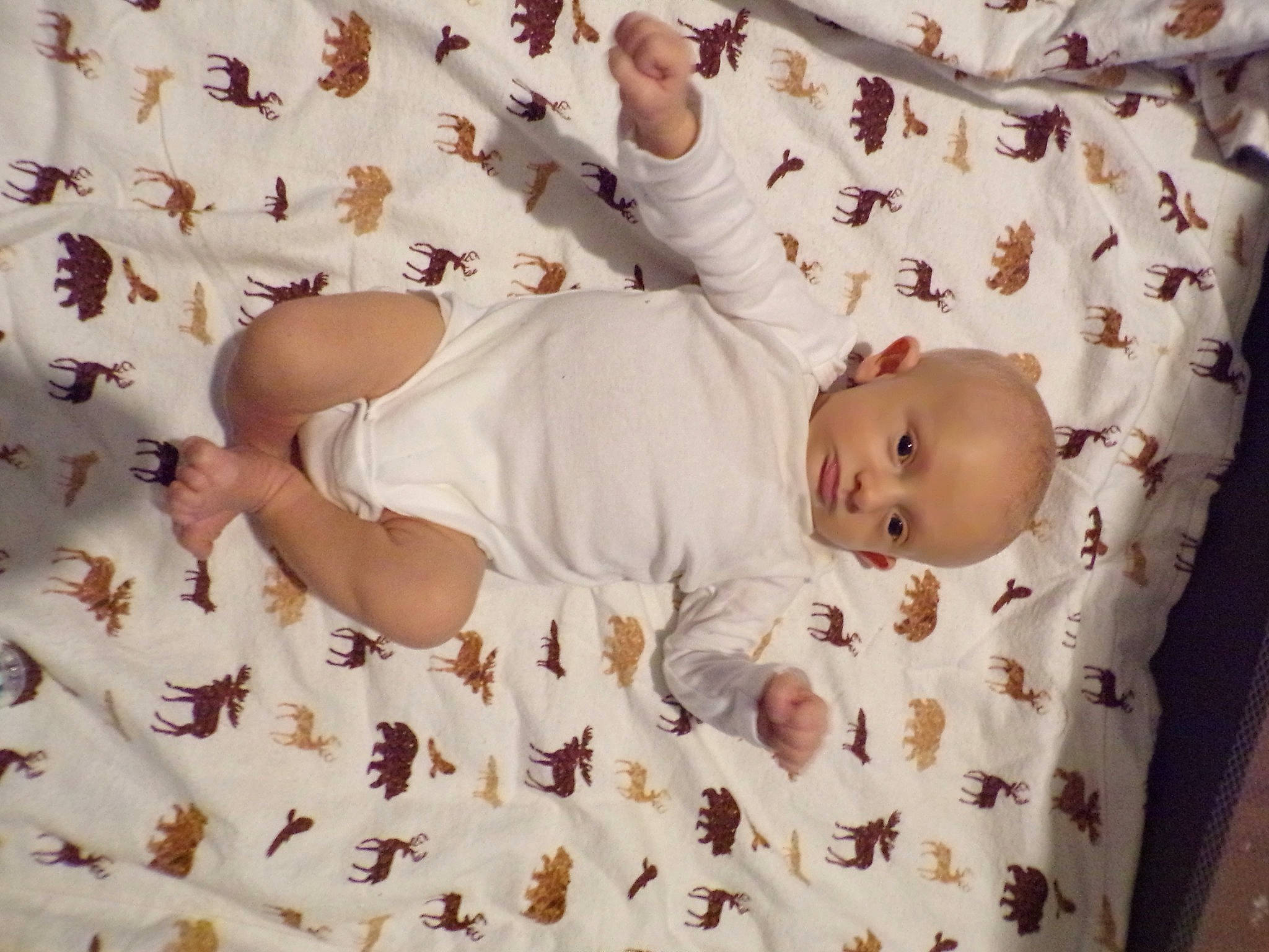 William is registered to the contest to win money with this photo: baby, baby_products, baby_sleeping, baby_toddler_clothing, bed_sheet, bedding, child, comfort, foot, gesture, head, human_leg, linens, pattern, person, room, skin, sleeve, textile, thigh