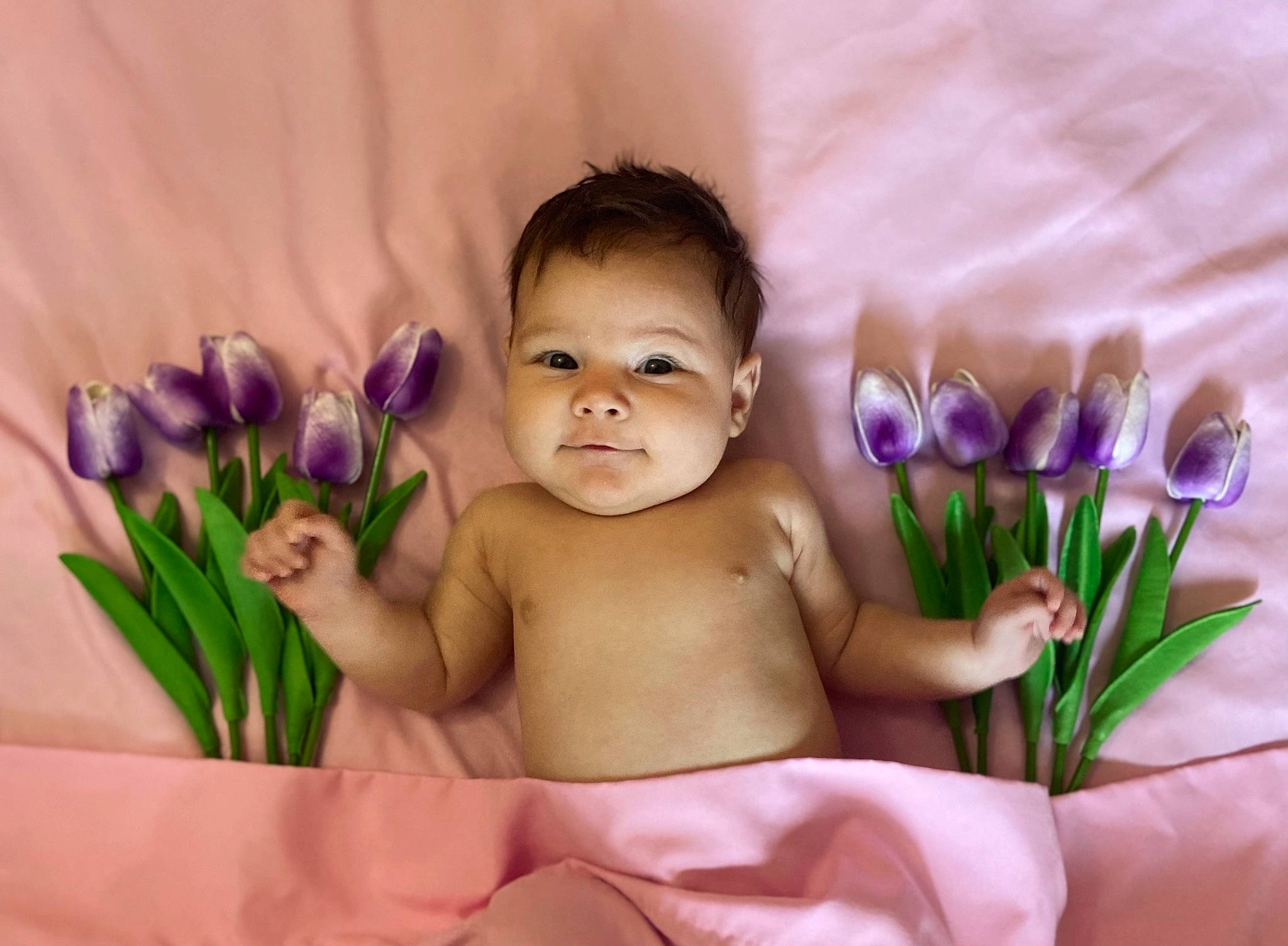 Adelyn joined the competition — help win amazing prizes! arm, baby, baby_toddler_clothing, cheek, eyebrow, face, facial_expression, finger, flower, grass, hand, happy, iris, people_in_nature, person, petal, pink, plant, skin, smile