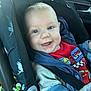 Gabin participe au concours pour gagner de l'argent avec cette photo : baby, blue_jacket, car_interior, car_seat, child, clothing, cute, drool, face, happy, infant, jacket, person, portrait, racing_car, red_shirt, seatbelt, smile, strapped_in, young_child