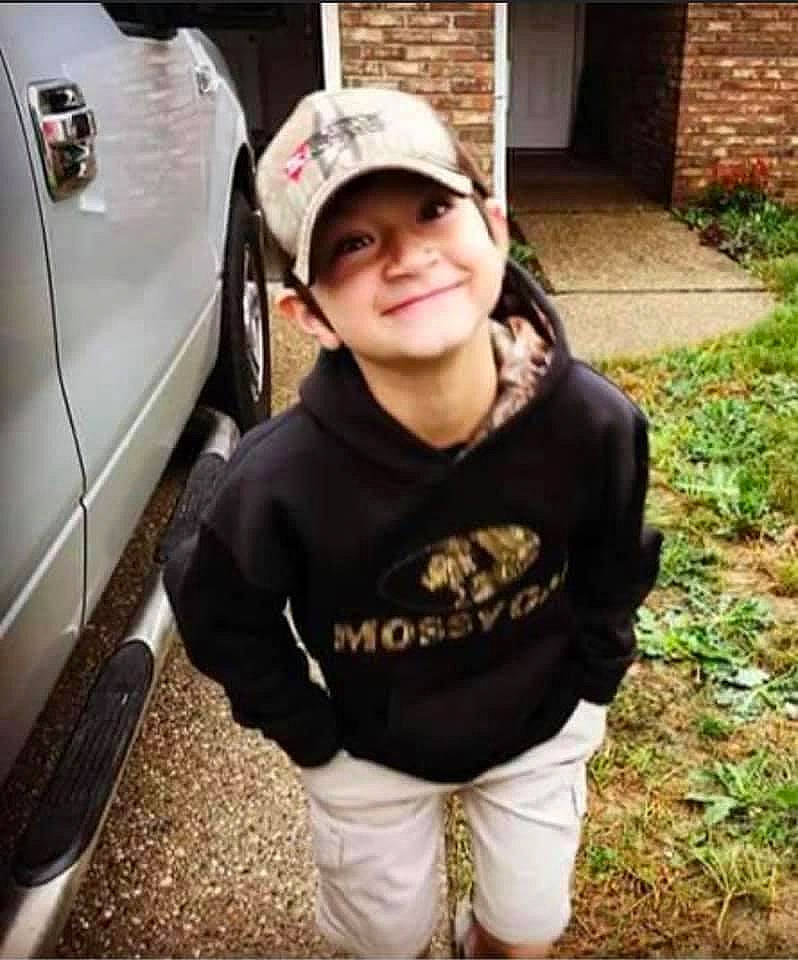 Jaxon is registered to the contest to win money with this photo: automotive_design, automotive_lighting, automotive_tire, baseball_cap, bumper, cap, cool, face, fender, grass, headwear, joy, motor_vehicle, person, personal_protective_equipment, plant, sleeve, smile, street_fashion, t_shirt