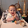 Connor joined the competition — help win amazing prizes! baby, balance_scale, child, clothing, cushion, decor, face, figurine, hand, happy, high_chair, indoor, light_hair, mouth_open, person, seated, smiling, star_pattern, table, toy