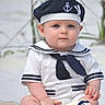 baby, child, sailor_outfit, hat, blue_eyes, toy, life_preserver, sitting, outdoor, cute, portrait, clothing, infant, person, navy_theme, white_clothes, barefoot, summer, young_child, serious_expression