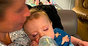 Connor joined the competition — help win amazing prizes! adult, baby, blurred_face, bottle, casual, child, clothing, comfort, couch, family, feeding, feeding_time, holding, home, indoor, infant, lamp, person, relaxing, sleepy