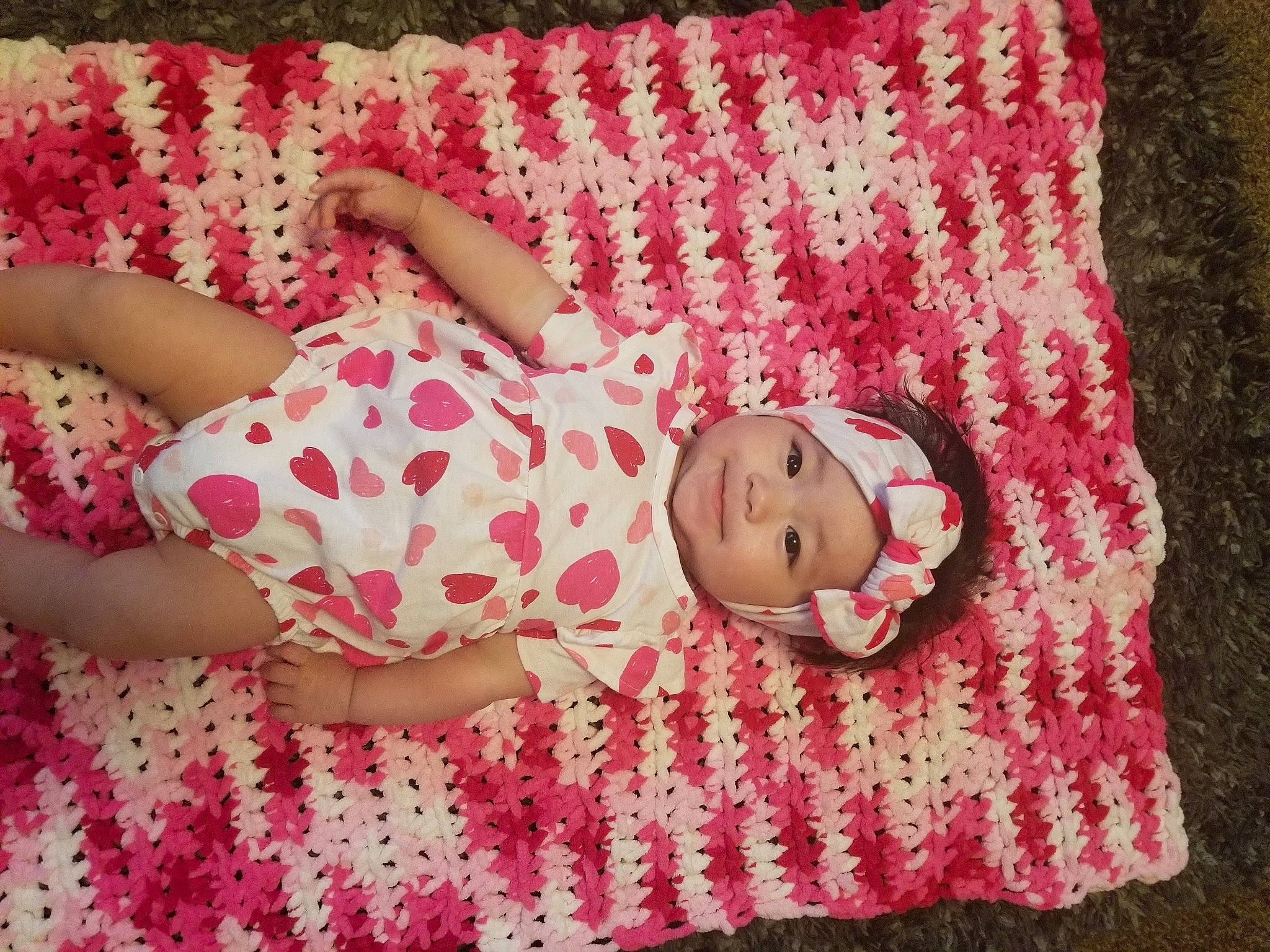 Amari joined the competition — help win amazing prizes! baby_toddler_clothing, beauty, bedding, child, comfort, couch, grass, happy, headwear, human_leg, joy, linens, magenta, pattern, peach, person, pink, skin, sleeve, textile