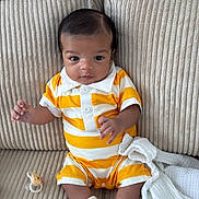 Zahir a rejoint le concours — aidez-le/la à gagner de superbes lots ! baby, infant, child, couch, pillow, striped_clothing, yellow, white, socks, pacifier, indoor, portrait, cute, seated, soft_fabric, furniture, curious, small_hands, head, face