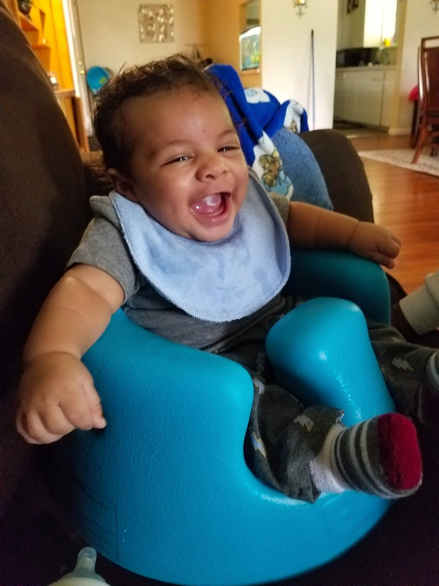 Ozias joined the competition — help win amazing prizes! arm, baby, blue, chair, child, facial_expression, finger, fun, furniture, laugh, leg, person, play, sitting, smile, teal, toddler, turquoise