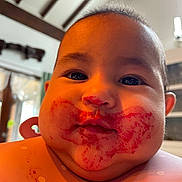 Paolina participe au concours pour gagner de l'argent avec cette photo : baby, face, food_stains, messy, indoor, child, curious, close_up, cheeks, bib, polka_dots, young_child, expression, head, person, portrait, warm_light, home_interior, dark_eyes, hair