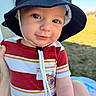 toddler, child, hat, striped_shirt, outdoor, sunny, grass, portrait, smile, baby, face, blue_eyes, summer, casual_clothing, cute, person, skin, human, daytime, young