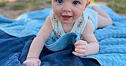 Anthony is registered to the contest to win money with this photo: baby, towel, outdoor, smiling, face, blue, child, infant, blanket, grass, sunlight, happy, portrait, person, summer, nature, cute, head, skin, eyes