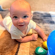Anthony joined the competition — help win amazing prizes! baby, child, infant, smile, face, eyes, carpet, floor, toy, colorful, playtime, crawling, home, cute, skin, short_hair, white_clothing, indoors, person, happy