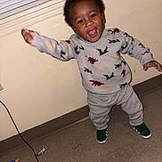 Emon joined the competition — help win amazing prizes! toddler, child, dinosaur_sweater, green_shoes, indoor, floor, window_blinds, joyful, smiling, standing, arms_outstretched, beige_wall, clothing, person, portrait, happy, casual, cute, young_child, playful