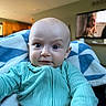 Knox joined the competition — help win amazing prizes! baby, bald_head, blanket, blue_eyes, child, closeup, cozy, curious, cute, furniture, home, indoor, infant, living_room, person, portrait, smiling, soft_light, television, turquoise_clothing