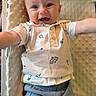 arms, baby, child, clothing, cushion, cute, expression, eyes, happy, head, indoor, infant, mouth, person, photography, polo_shirt, shorts, skin, smile, texture