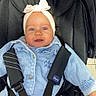 Léonie participe au concours pour gagner de l'argent avec cette photo : baby, black_canopy, blue_eyes, bow, buckle, car_seat, child, closeup, clothing, cute, denim_jacket, fabric, harness, headband, infant, portrait, safety_strap, sitting, smile, stroller