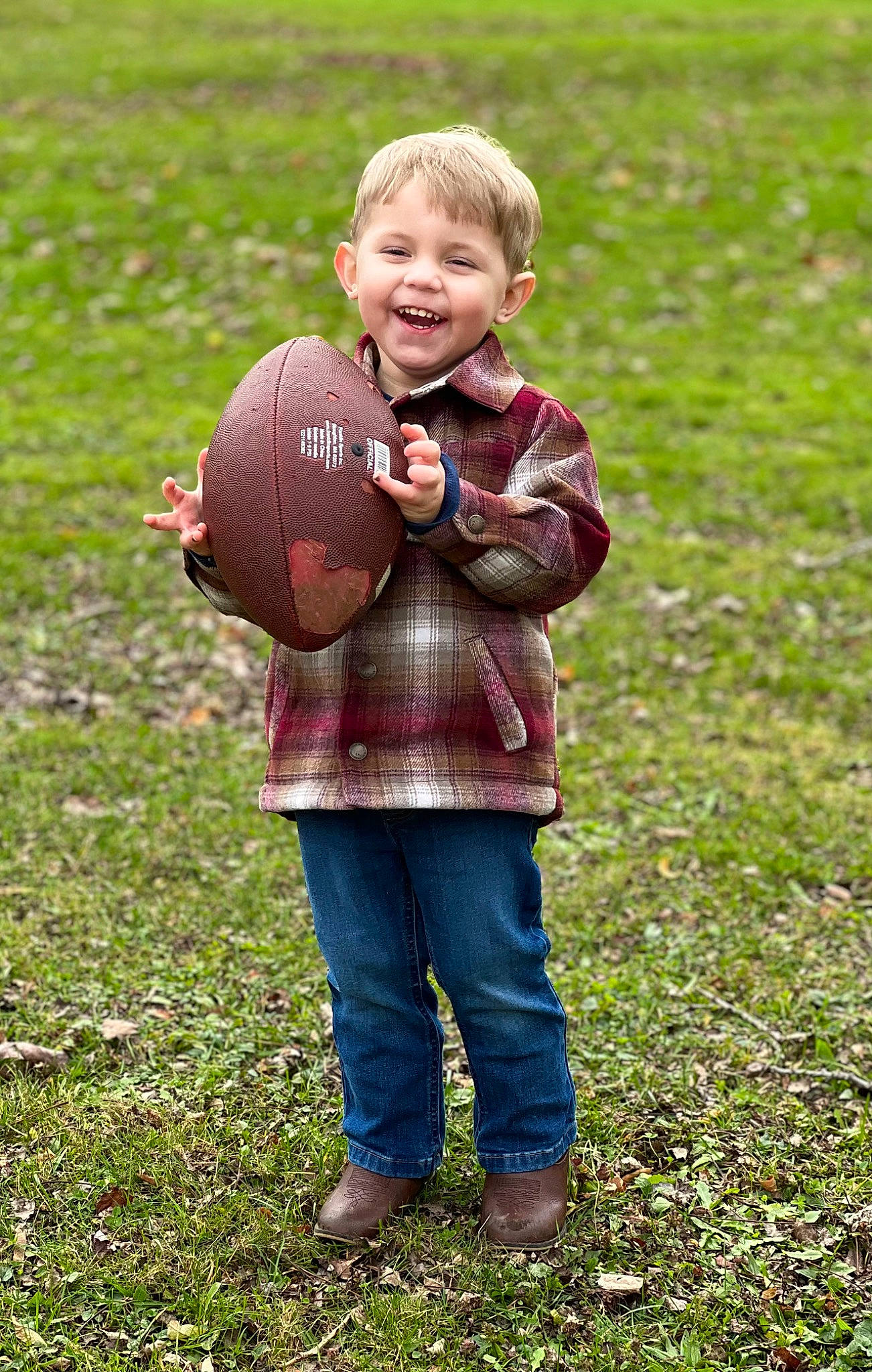 Damian is registered to the contest to win money with this photo: ball, blond, child, fun, grass, grass_family, grassland, happy, jeans, joy, lawn, leisure, meadow, people_in_nature, person, plant, prairie, sitting, smile, sports_equipment