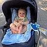 baby, stroller, blanket, smiling, happy, outdoor, sunlight, infant, clothing, toy, foot, hand, person, blue, toddler, seat, child, cute, park, daytime