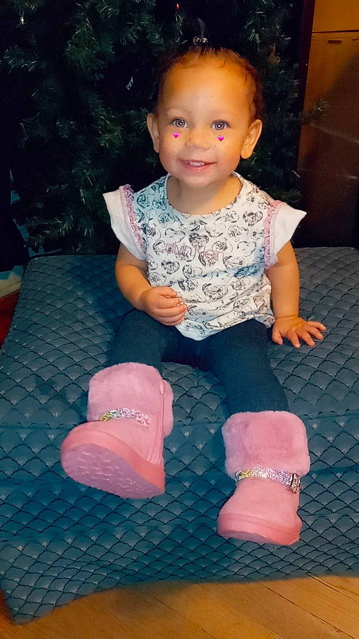 Avianna is registered to the contest to win money with this photo: baby_toddler_clothing, beauty, cheek, child, comfort, finger, flash_photography, flooring, flowerpot, hairstyle, human_body, joy, leg, person, pink, purple, skin, sleeve, smile, sock