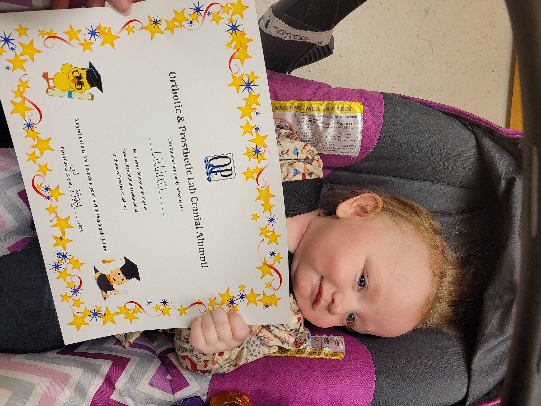 Lillian is registered to the contest to win money with this photo: baby, baby_products, baby_toddler_clothing, book, car_seat, chair, child, comfort, font, fun, happy, magenta, person, photograph, product, publication, purple, room, sitting, toddler