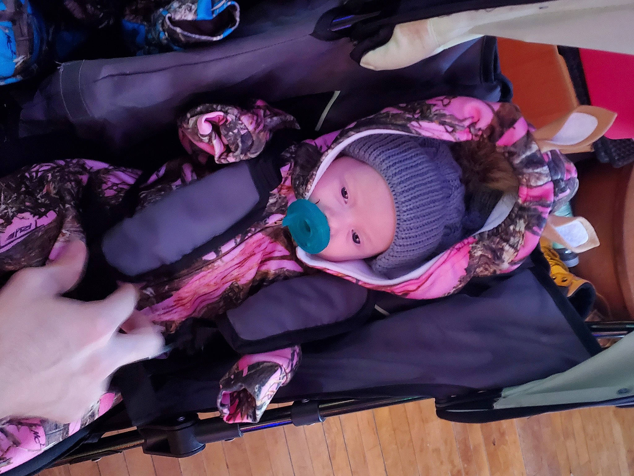 Zephira is registered to the contest to win money with this photo: baby, baby_toddler_clothing, beanie, bonnet, costume, costume_accessory, headgear, knit_cap, magenta, person, pink, purple, violet, wood_flooring