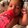 baby, beverage, blanket, bodypart, bottle, can, cup, drinking, face, finger, hand, head, juice, newborn, person, photography, portrait, tin, towel, waterbottle