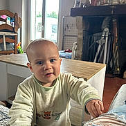 Mathis a rejoint le concours — aidez-le/la à gagner de superbes lots ! toddler, child, indoor, sweatshirt, curious, face, hand, furniture, table, chair, window, blanket, home, living_room, person, baby, expression, clothing, floor, plant