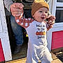 toddler, child, beanie, onesie, pumpkin, hands, adult, support, porch, wood, sunlight, outdoor, smile, walking, clothing, footwear, door, jeans, sweatshirt, happy
