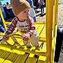 Jack joined the competition — help win amazing prizes! toddler, child, beanie, yellow, playground, steering_wheel, outdoor, autumn, pumpkin, clothing, toy_vehicle, sunlight, park, person, hat, footwear, curious, daylight, hands, face
