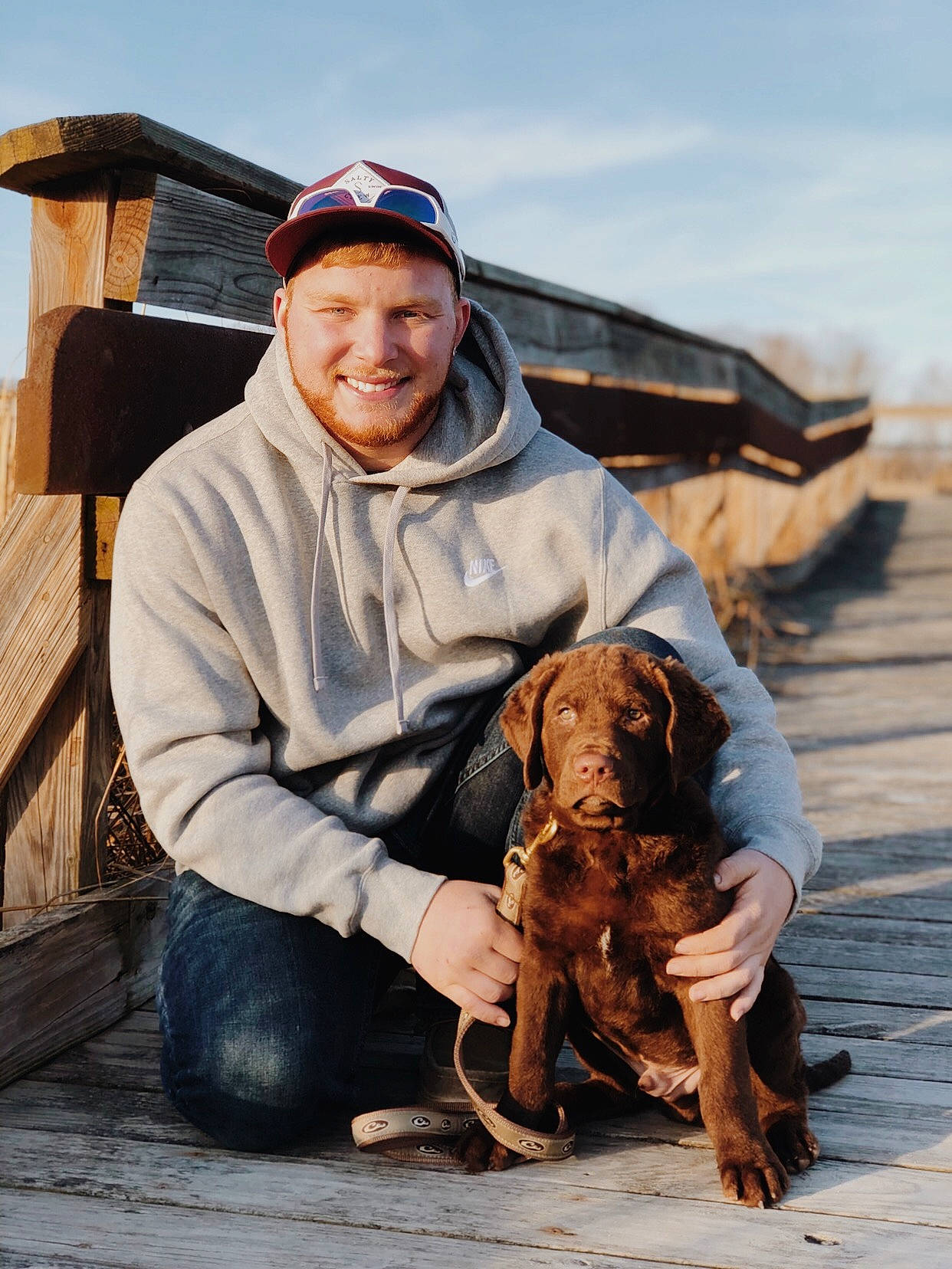 Creek joined the competition — help win amazing prizes! baseball_cap, cap, carnivore, companion_dog, dog, dog_breed, fawn, happy, hat, jacket, landscape, liver, people, sky, smile, soil, vertebrate, wood, working_animal, wrinkle