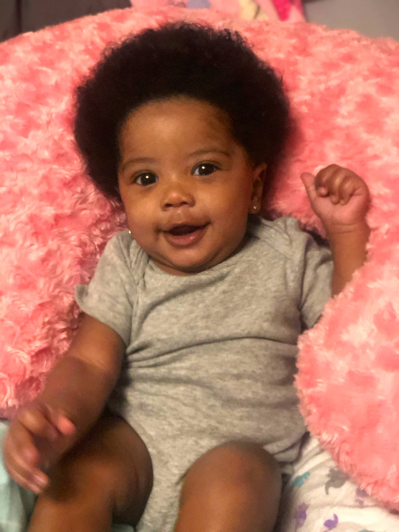Zylah is registered to the contest to win money with this photo: afro, baby, black_hair, cheek, child, eye, face, hair, head, lip, nose, person, pink, skin, smile, toddler