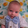 Charlie is registered to the contest to win money with this photo: baby, infant, child, smile, bow_tie, striped, shirt, suspenders, portrait, cute, face, head, colorful_background, floral_pattern, happy, young, indoors, closeup, person, fashion