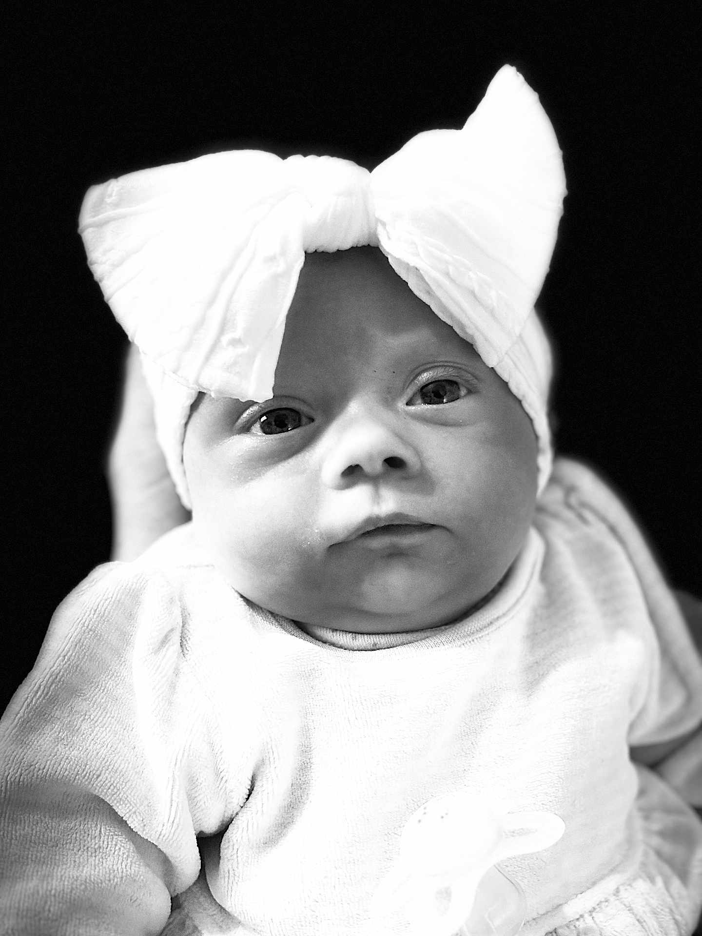 Raven Storm is registered to the contest to win money with this photo: adorable, baby, black_and_white, bow, child, close_up, clothing, cute, expression, eyes, face, headband, infant, monochrome, newborn, person, portrait, soft_texture, studio, young