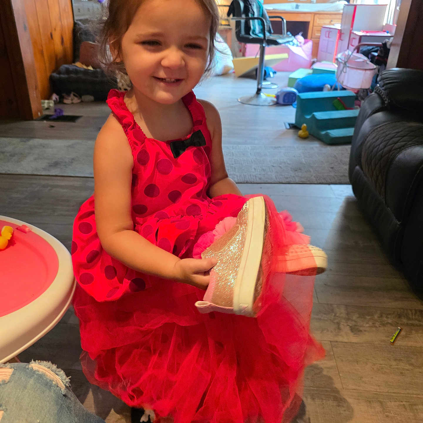 Annalise joined the competition — help win amazing prizes! child, toddler, girl, smiling, indoors, portrait, pink_dress, polka_dots, tulle, glittery_hat, fashion, playful, happy, sitting, living_room, home, toys, furniture, wood_floor, family_photo