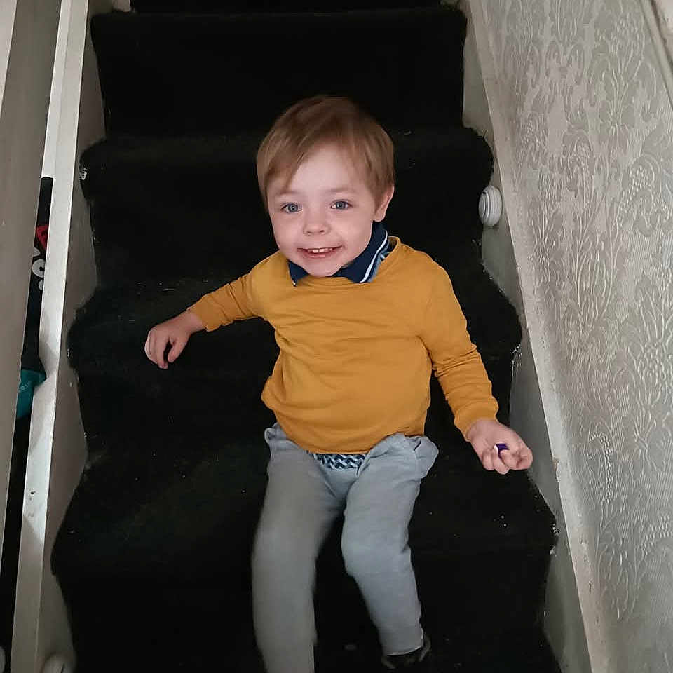 Leo Francis is registered to the contest to win money with this photo: architecture, baby, boy, building, child, clothing, face, happy, head, house, housing, jeans, male, pants, person, sitting, sleeve, sliding, smile, staircase