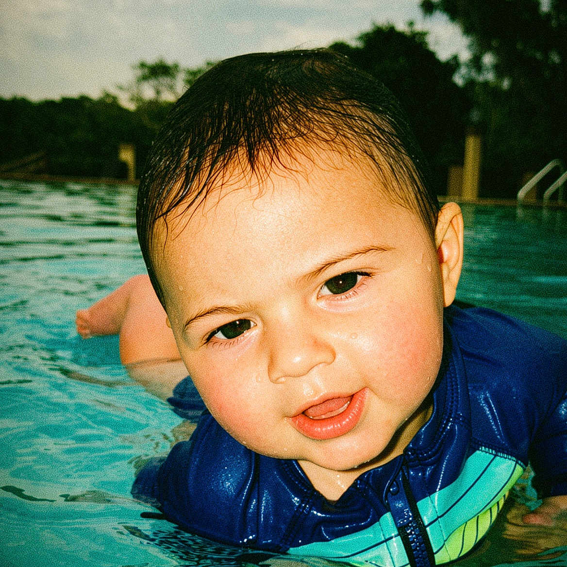 Ethan Zaid joined the competition — help win amazing prizes! child, toddler, swimming_pool, water, wet_hair, blue_swimsuit, outdoor, summer, playing, face, expression, young_child, skin, nature, trees, sky, recreation, fun, leisure, portrait