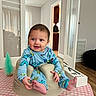 Ethan Zaid is registered to the contest to win money with this photo: baby, infant, pajamas, smile, happy, indoor, table, tablecloth, baby_seat, furniture, room, doorway, floor, wood_floor, window, curtains, child, person, playful, home