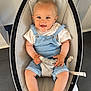 Dario a rejoint le concours — aidez-le/la à gagner de superbes lots ! baby, child, smiling, blue_eyes, denim_overalls, white_tshirt, baby_rocker, safety_strap, cute, happy, indoor, floor_tiles, barefoot, toes, person_feet, light_skin, short_hair, infant, comfortable, seated