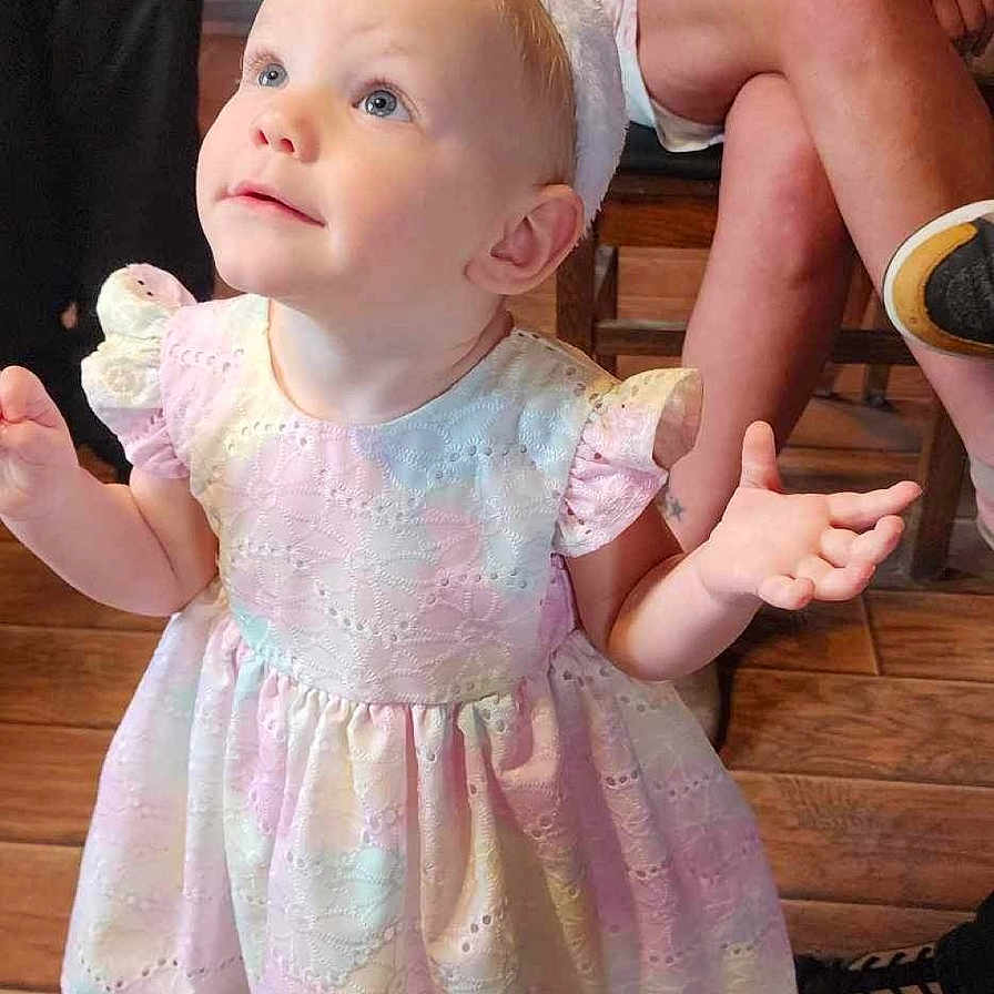 Camber is registered to the contest to win money with this photo: baby, bodypart, clothing, costume, couch, dress, face, finger, footwear, furniture, hand, head, person, photography, portrait, shoe, sitting, skin, tattoo, wood