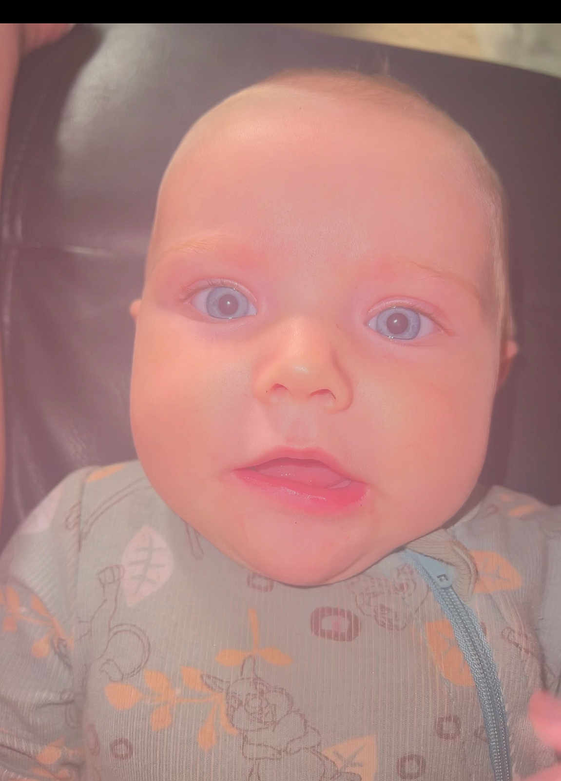 Luka joined the competition — help win amazing prizes! baby, child, face, blue_eyes, onesie, patterned_clothing, infant, close_up, portrait, seated, expression, leaves_pattern, animal_pattern, soft_lighting, indoor, cute, small_person, young_child, skin, head