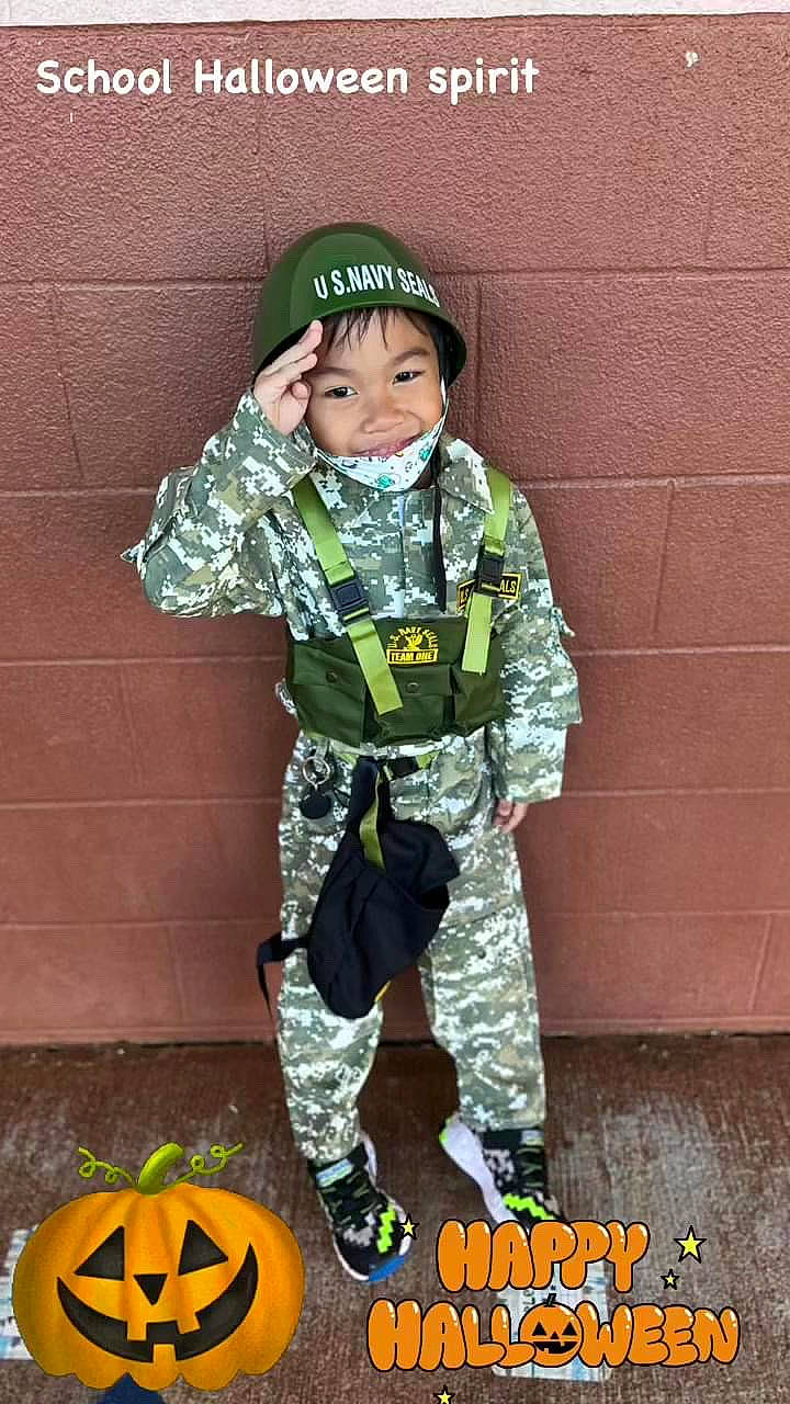 Lloyd Jayson is registered to the contest to win money with this photo: army, boot, calabaza, camouflage, cap, cargo_pants, headgear, headwear, infantry, military_camouflage, military_person, military_uniform, non_commissioned_officer, pattern, person, personal_protective_equipment, sleeve, smile, soldier, toddler