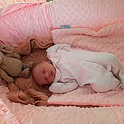 Aurelea joined the competition — help win amazing prizes! baby, newborn, sleeping, onesie, plush_toy, bunny, blanket, bassinet, pink, soft_texture, cozy, infant, child, cute, resting, bed, comfort, nursery, peaceful, portrait
