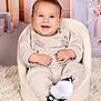 baby, child, smiling, knitwear, shoes, nike, chair, fluffy_rug, candles, gift_boxes, indoors, portrait, cute, happy, cozy, infant, sitting, fashion, warm, soft_lighting