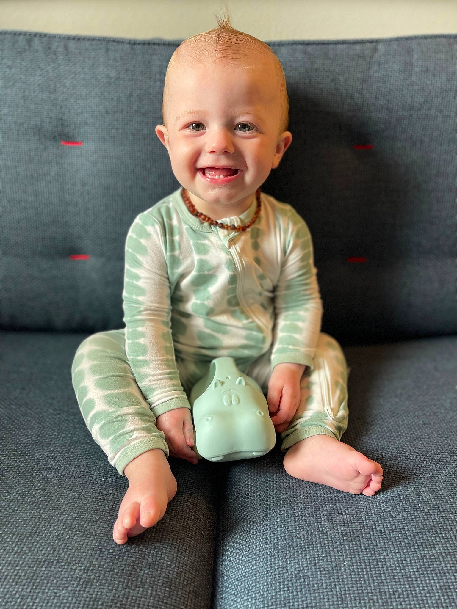 Everett is registered to the contest to win money with this photo: arm, baby, baby_toddler_clothing, barefoot, comfort, dress, face, flash_photography, flooring, foot, gesture, happy, head, human_body, joy, knee, person, skin, sleeve, smile