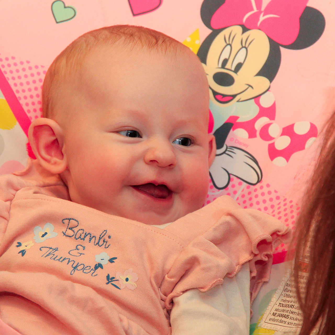 Séléna a rejoint le concours — aidez-le/la à gagner de superbes lots ! apparel, baby, baby_girl, child, closeup, colorful, cushion, cute, face, happy, head, indoor, infant, minnie_mouse, person, pink_clothing, portrait, smiling, soft_toys, young_child